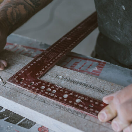 A tradesman drawing on concrete as part of a design and build project